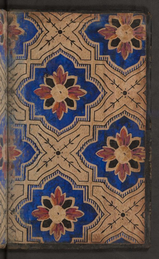 A cobalt floral endpaper. Repeated shapes turn the opening of a book into a carefully ordered surface.